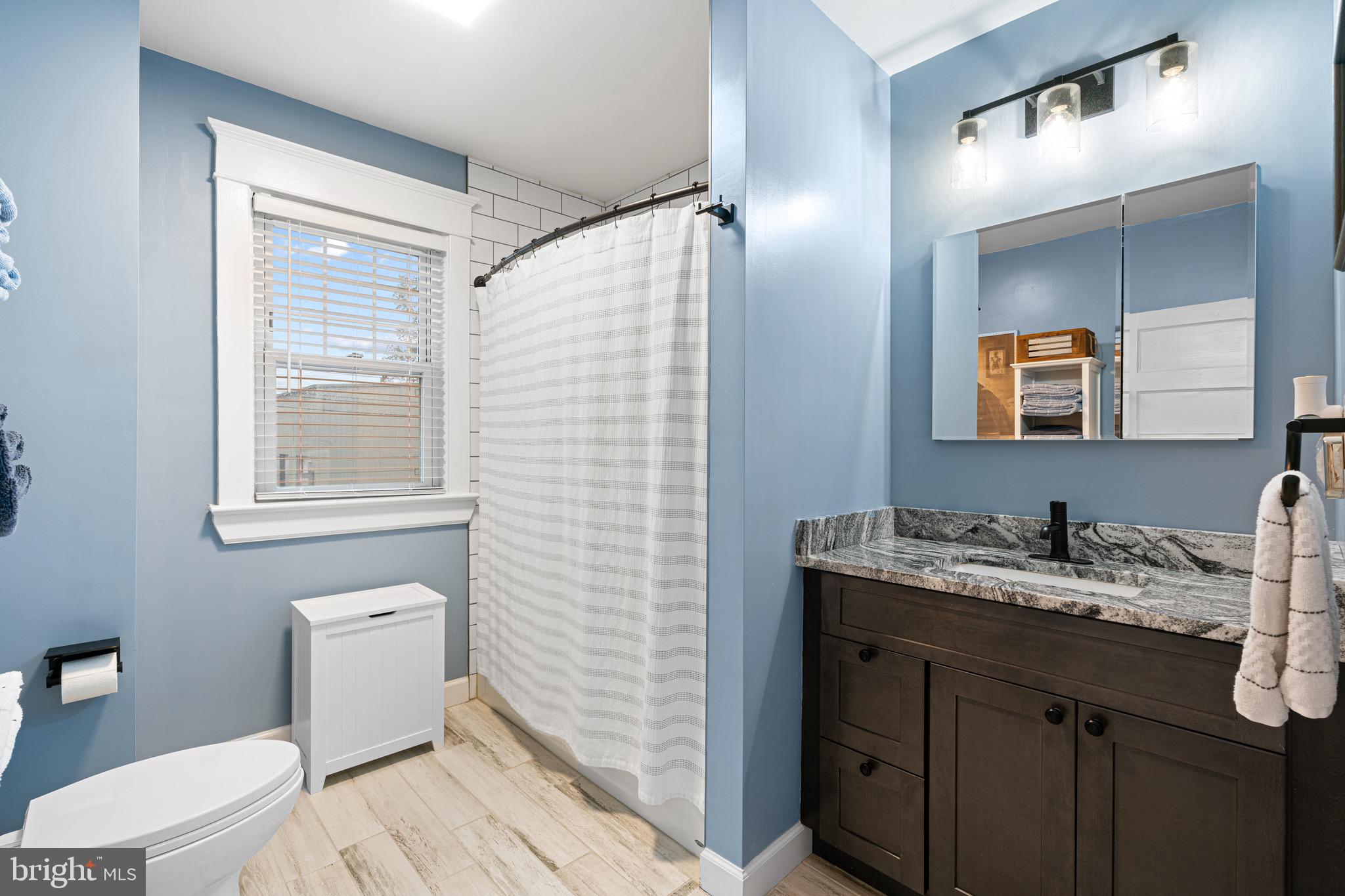 227 7th Avenue Haddon Heights, NJ 08035 - Photo 16 of 26 a bathroom with a granite countertop sink toilet and mirror