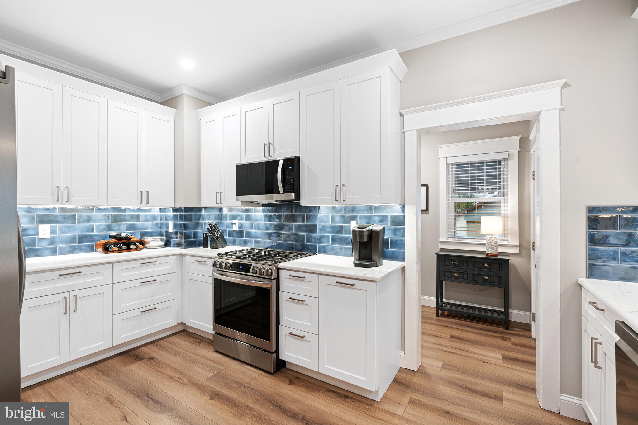 227 7th Avenue Haddon Heights, NJ 08035 - Photo 8 of 26 a kitchen with white cabinets and white appliances