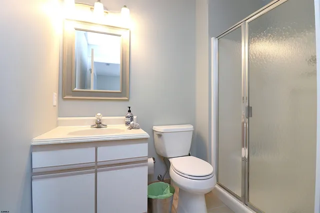 a bathroom with a toilet a sink and mirror