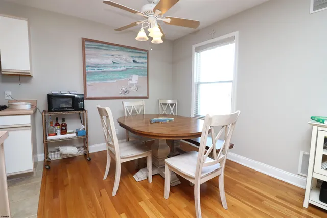 a view of a dining room with furniture wooden floor and a chandelier