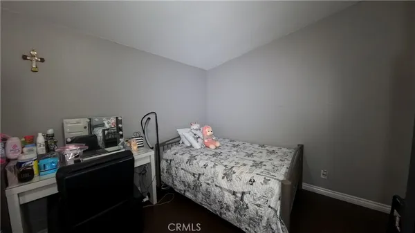 a bedroom with a bed and a dresser in it