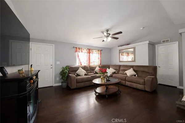 a living room with furniture and wooden floor