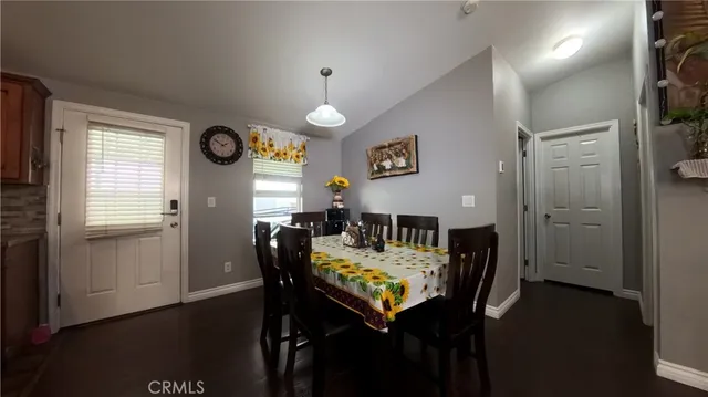 a view of a dining room with furniture and a window