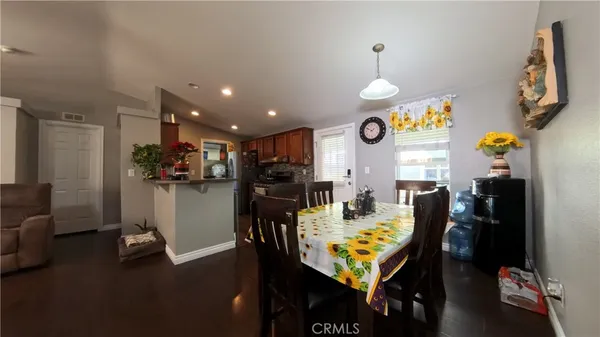 a view of a dining room with furniture and a chandelier