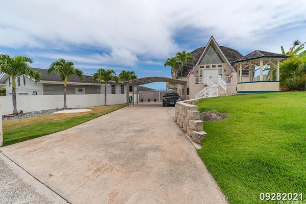a view of a house with a yard and sitting area