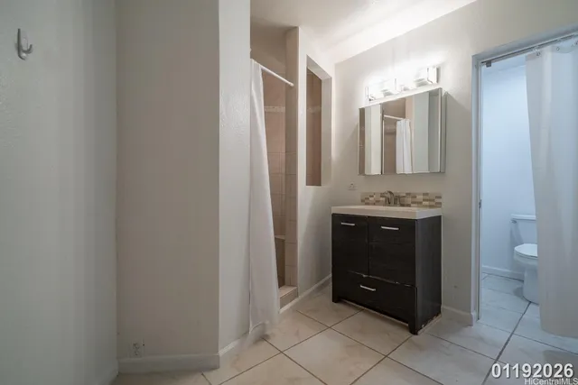 a bathroom with a toilet a sink and a mirror