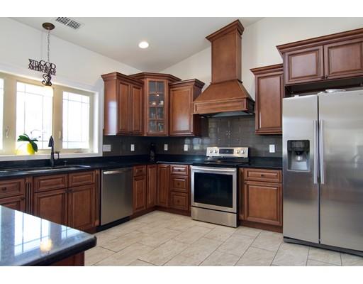68 Alwin Place Springfield, MA 01128 - Photo 9 of 30 a kitchen with stainless steel appliances granite countertop a stove a sink dishwasher and cabinets