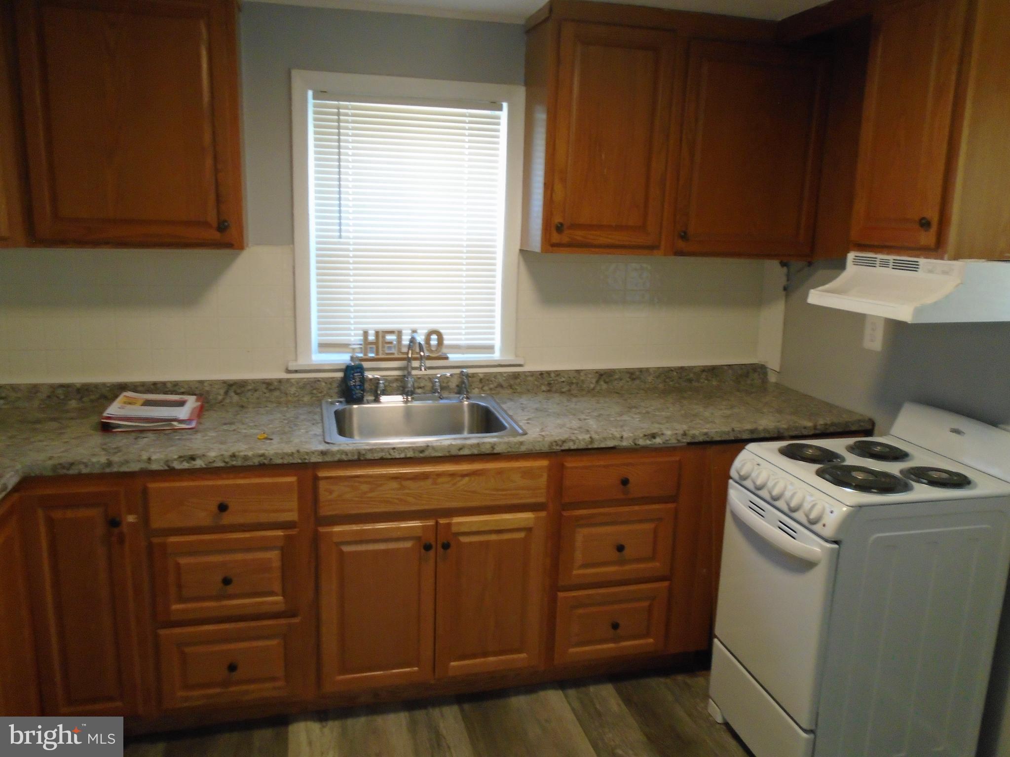 422 Wampler Road Baltimore, MD 21220 - Photo 4 of 10 a kitchen with cabinets appliances and a sink