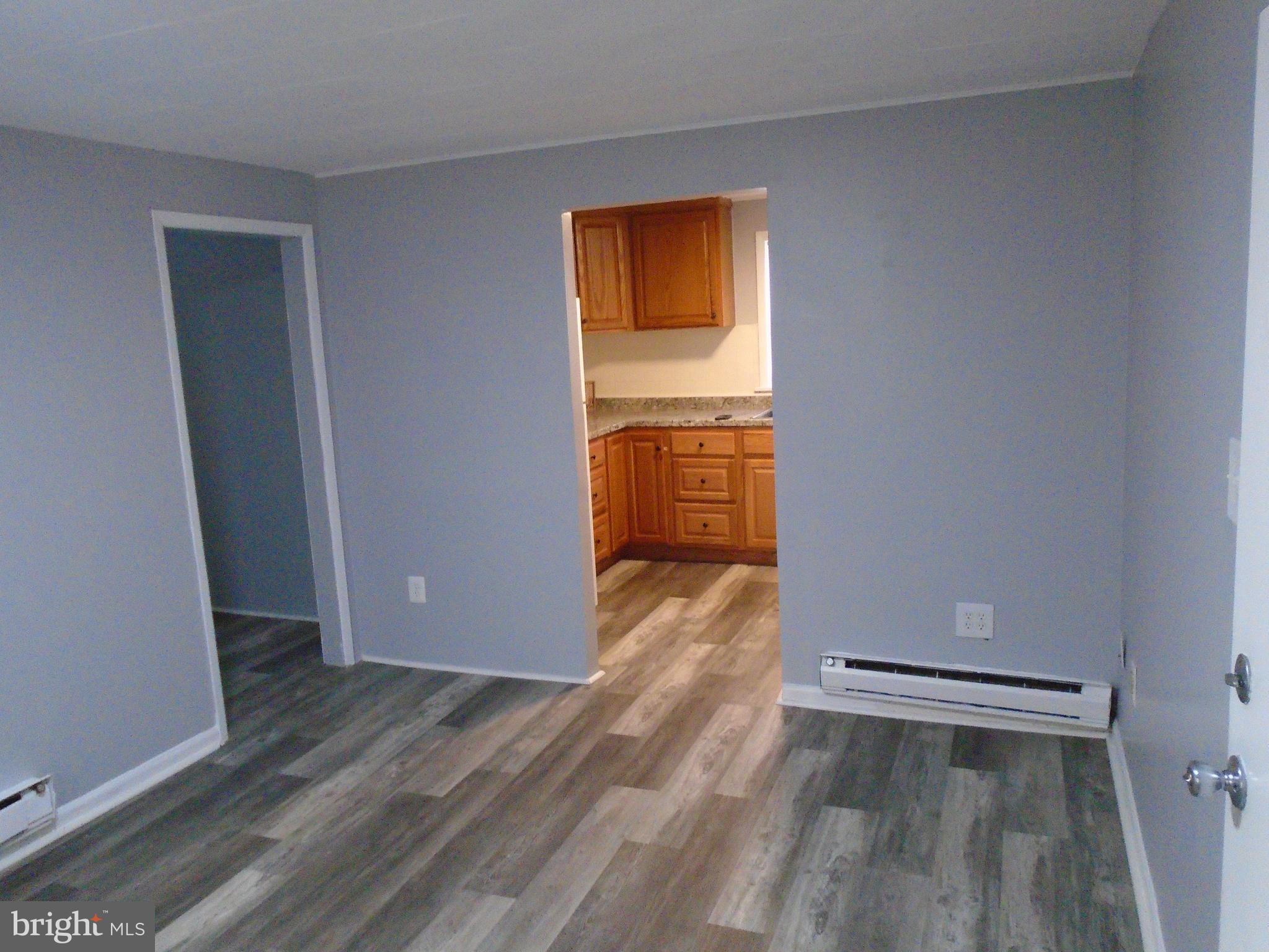 422 Wampler Road Baltimore, MD 21220 - Photo 7 of 10 an empty room with wooden floor and closet