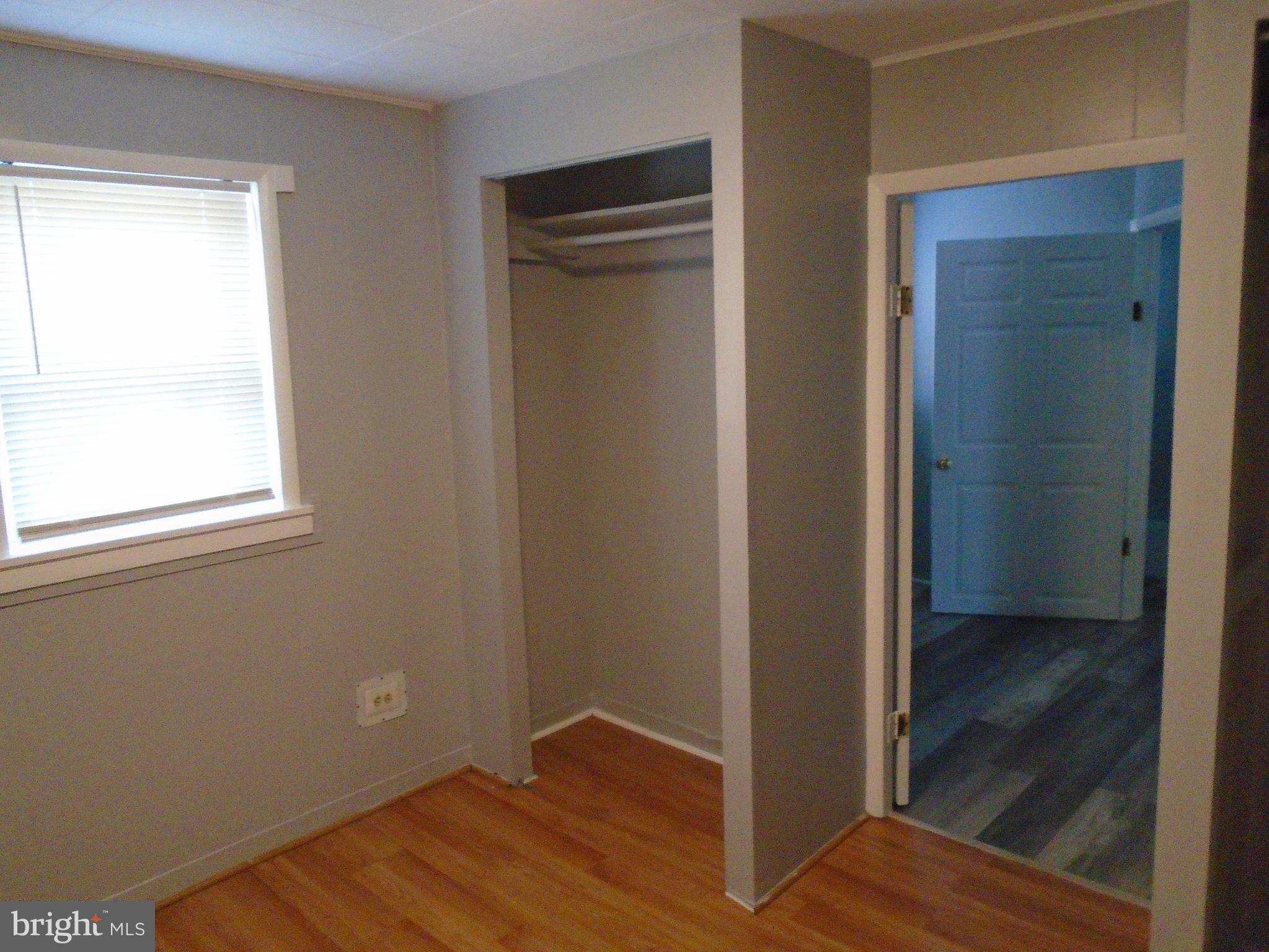 422 Wampler Road Baltimore, MD 21220 - Photo 9 of 10 a view of an empty room with wooden floor and closet