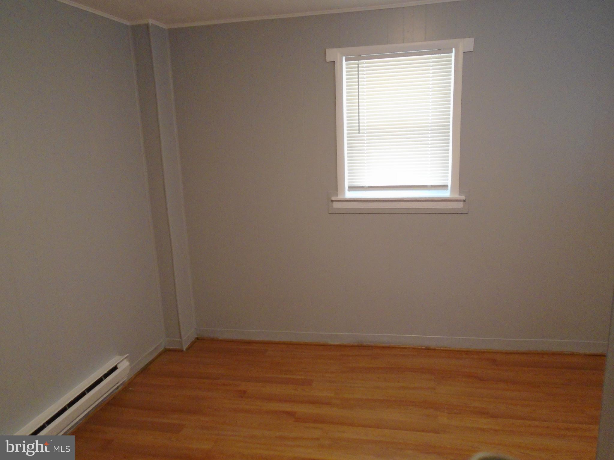 422 Wampler Road Baltimore, MD 21220 - Photo 10 of 10 a view of an empty room with wooden floor and a window