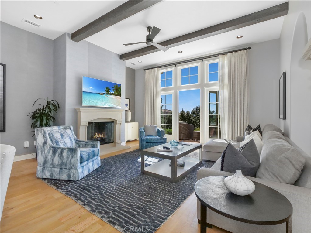 a living room with furniture fireplace and a large window
