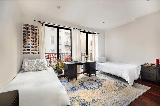 a bedroom with a large bed and a window