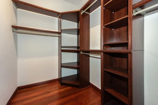 a view of walk in closet with empty racks