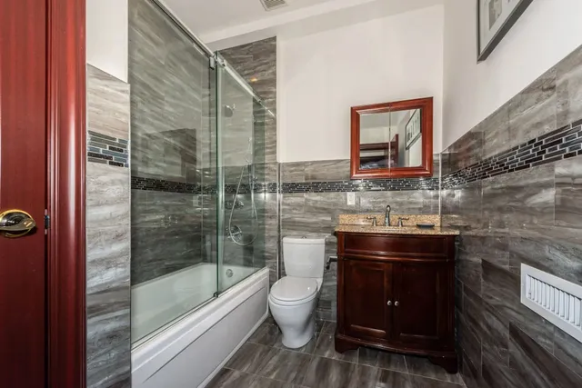 a bathroom with a toilet and a shower
