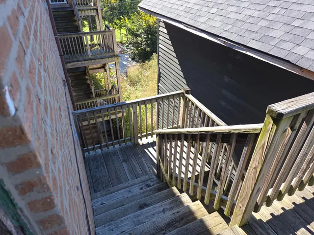 a view of balcony with wooden floor and stairs