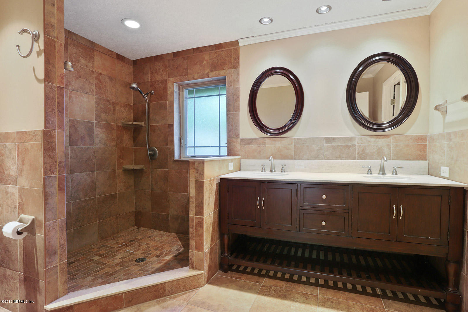 9482 Wexford Road Jacksonville, FL 32257 - Photo 13 of 25 a bathroom with a double vanity sink and a mirror