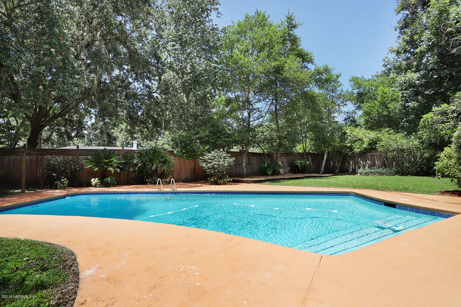 9482 Wexford Road Jacksonville, FL 32257 - Photo 14 of 25 a view of a swimming pool with an outdoor space and seating area