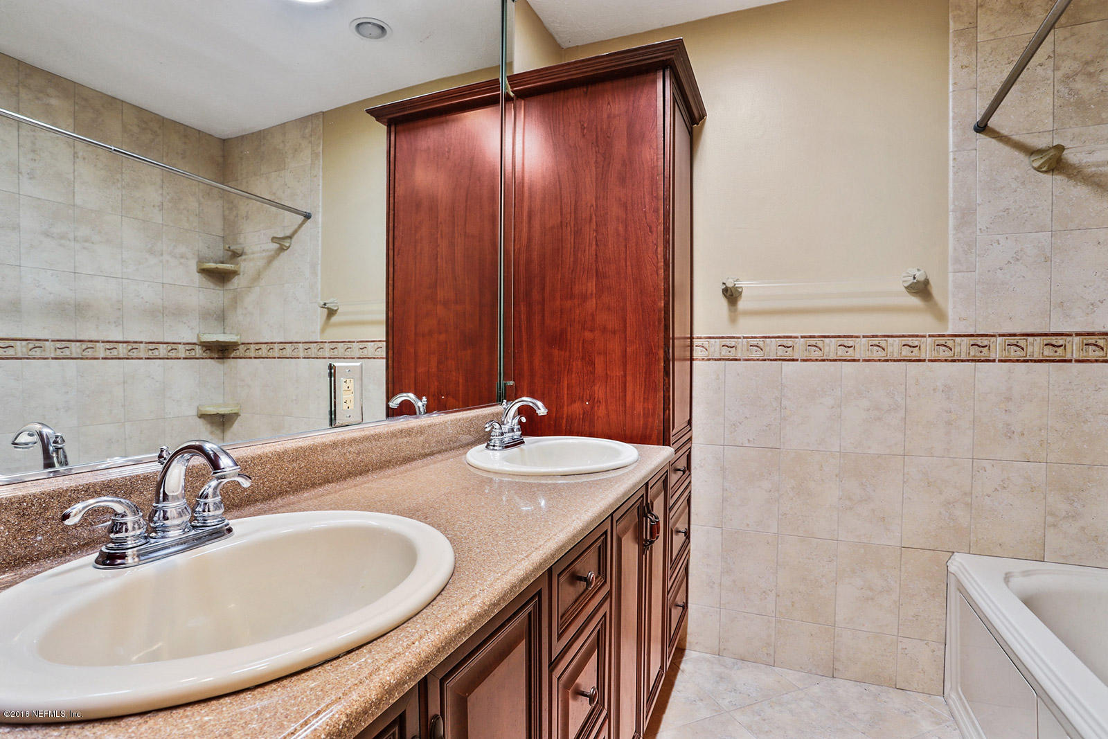 9482 Wexford Road Jacksonville, FL 32257 - Photo 23 of 25 a bathroom with a sink and a mirror
