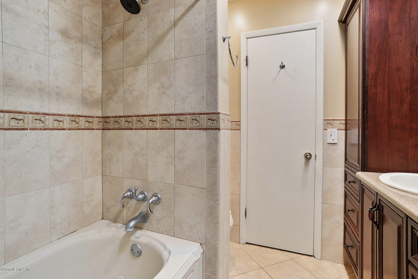 9482 Wexford Road Jacksonville, FL 32257 - Photo 24 of 25 a bathroom with a sink a tub and shower