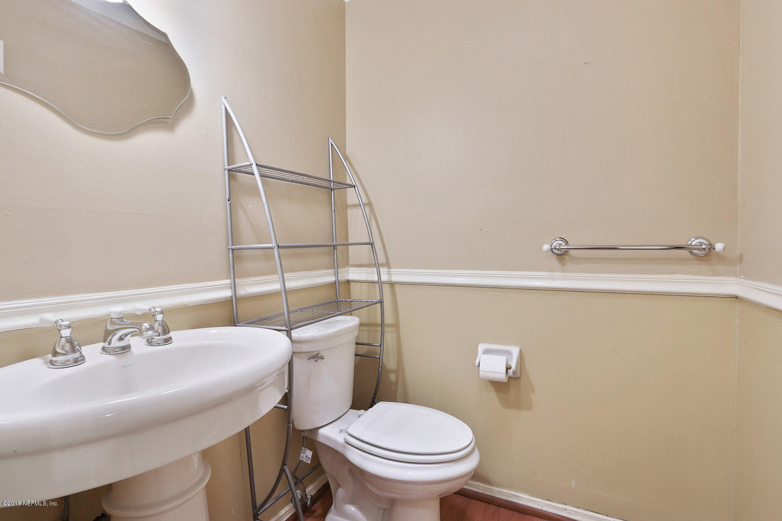 9482 Wexford Road Jacksonville, FL 32257 - Photo 25 of 25 a bathroom with a sink a toilet and a mirror