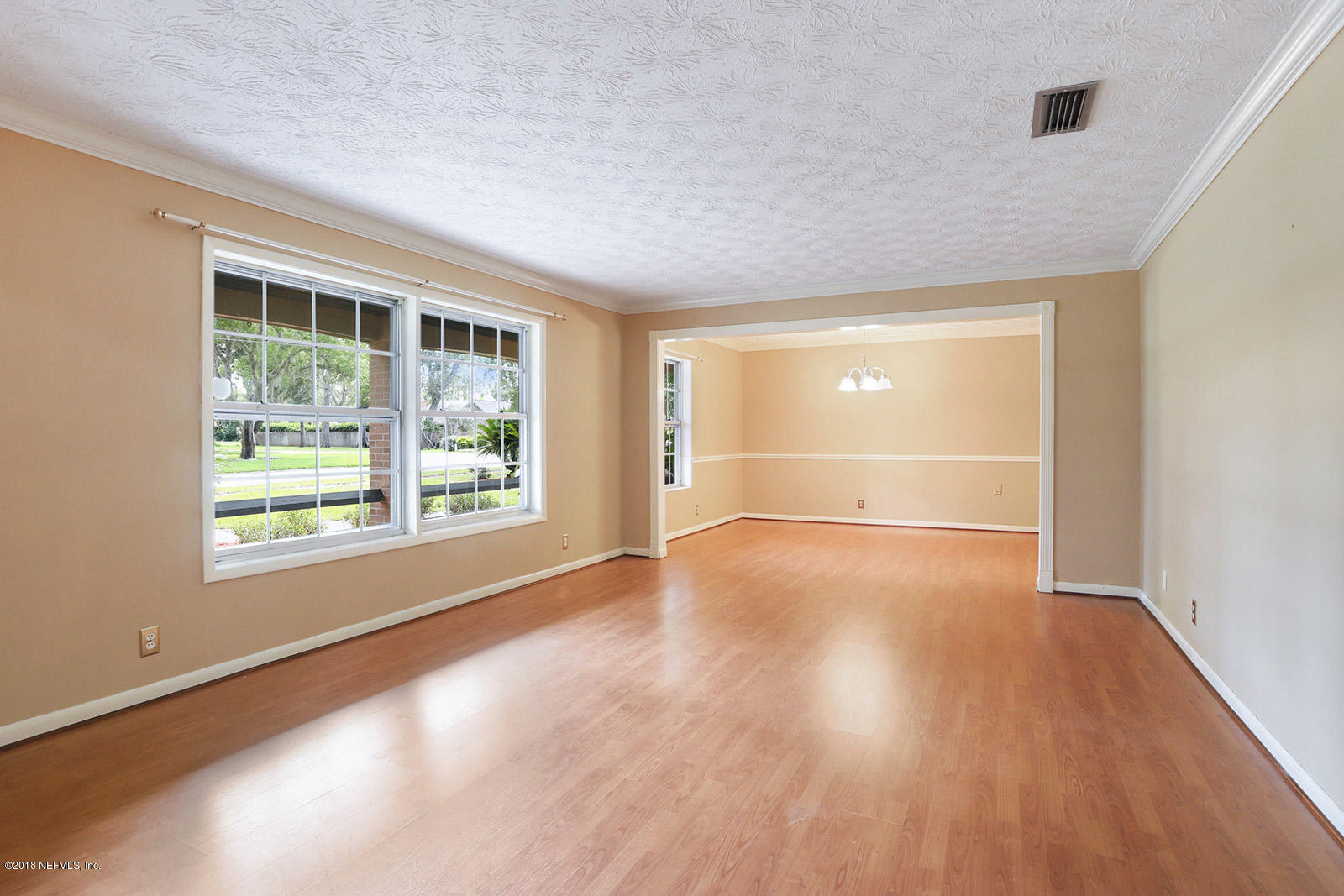 9482 Wexford Road Jacksonville, FL 32257 - Photo 3 of 25 an empty room with wooden floor and windows