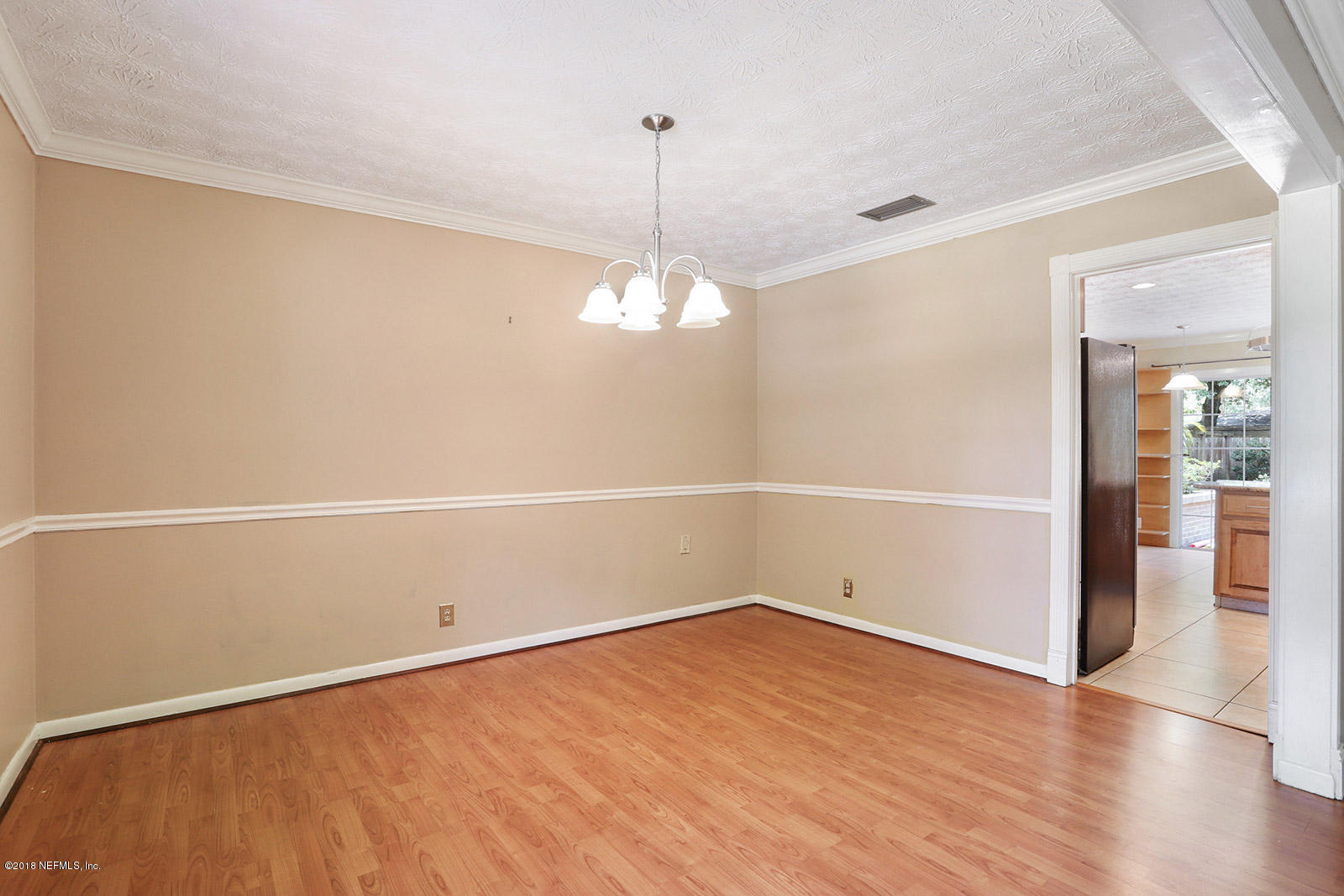 9482 Wexford Road Jacksonville, FL 32257 - Photo 4 of 25 a view of a room with wooden floor and white walls