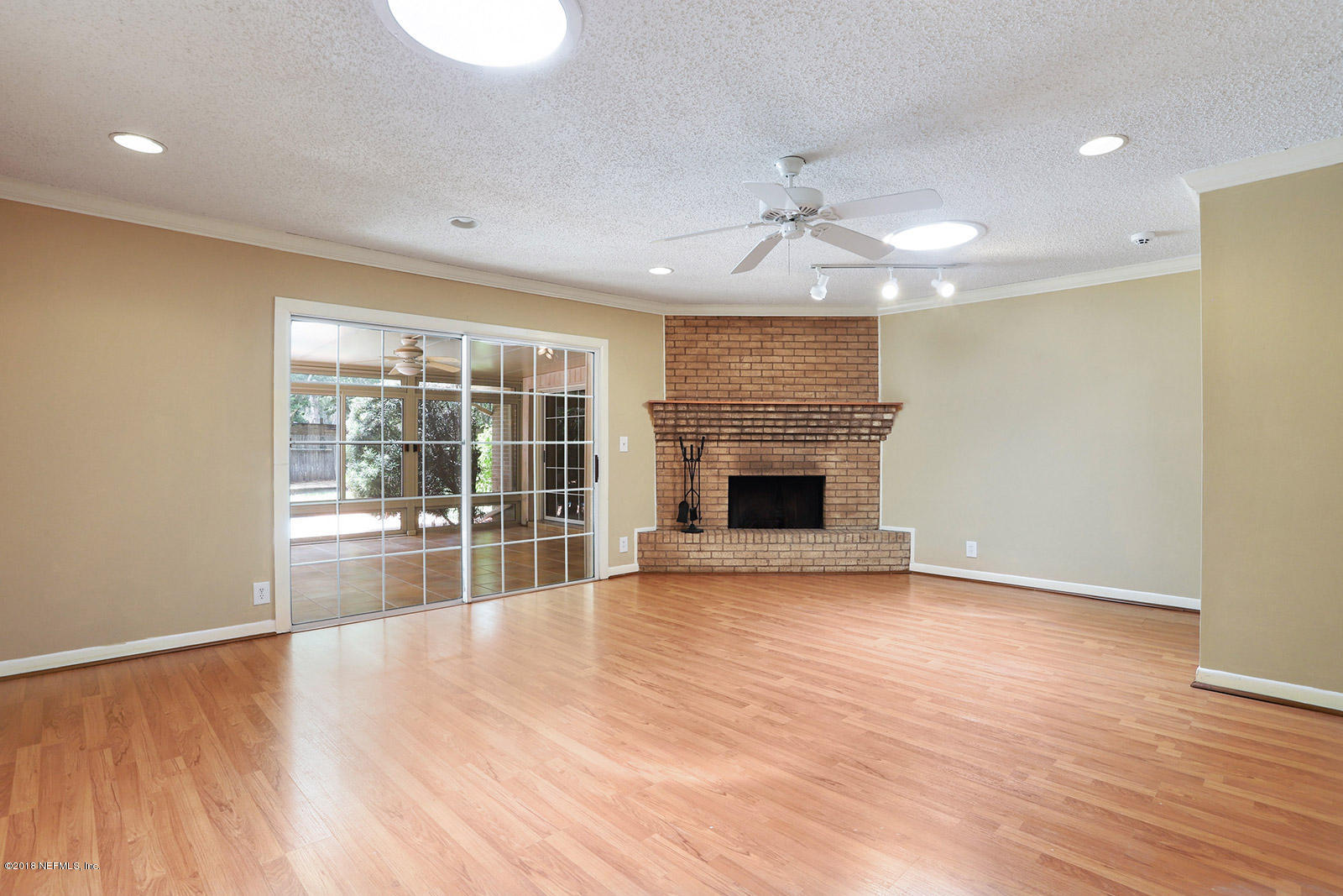 9482 Wexford Road Jacksonville, FL 32257 - Photo 5 of 25 a view of empty room with wooden floor and fireplace