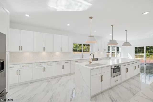 a kitchen with granite countertop white cabinets and white appliances