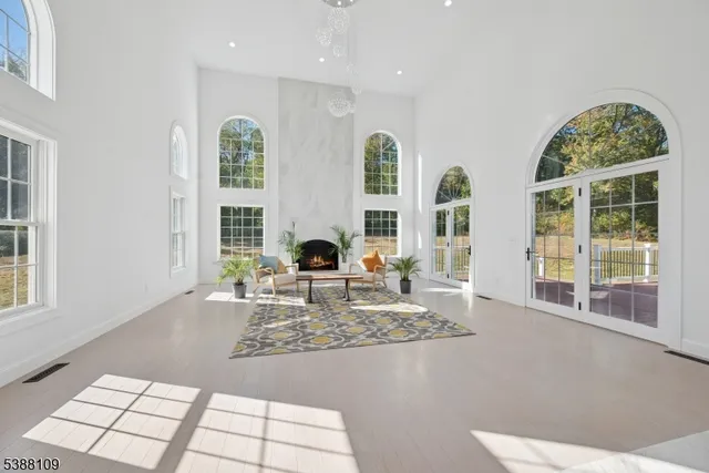 a living room with fireplace furniture and a large window
