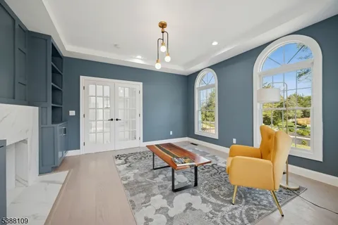 a living room with furniture and a chandelier
