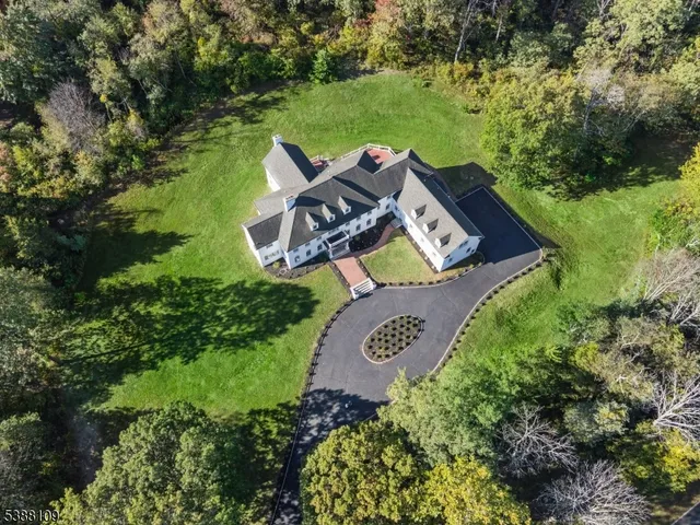 an aerial view of a house with garden space and street view