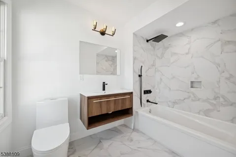 a bathroom with a bathtub toilet and sink