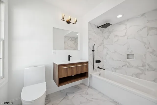 a bathroom with a bathtub toilet and sink