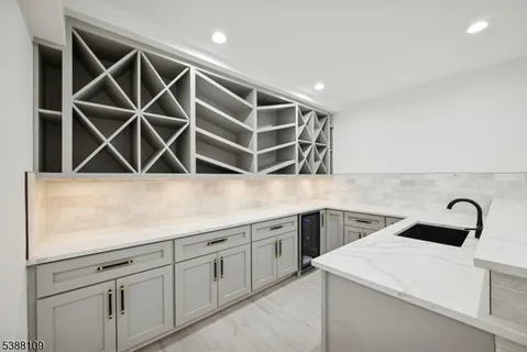 a view of a storage and utility room with sink dryer and washer