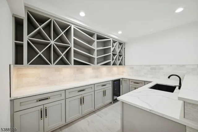 a view of a storage and utility room with sink dryer and washer