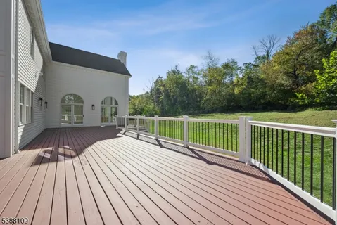a view of balcony with wooden floor and fence