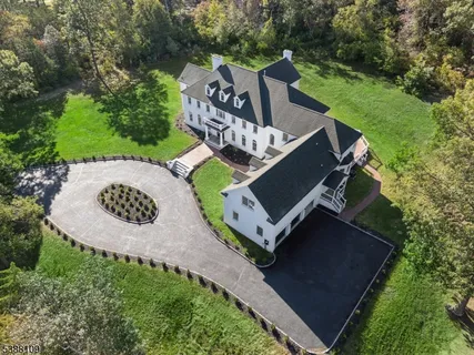 an aerial view of a house with backyard