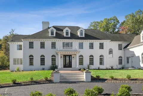 a view of a white house with a yard and plants