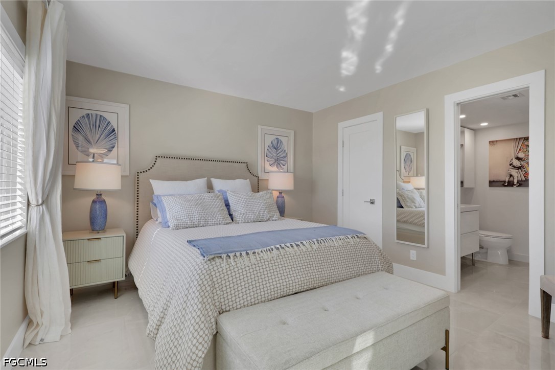 9 High Point Circle North, Unit 101 Naples, FL 34103 - Photo 19 of 49 a bedroom with a bed and a view of bathroom