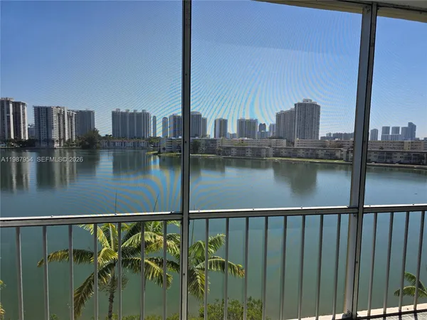 a view of a lake with a city from a balcony