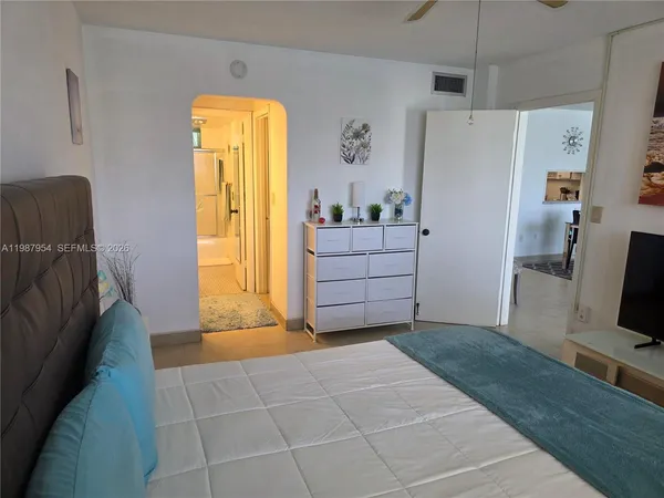 a bathroom with a tub shower and mirror