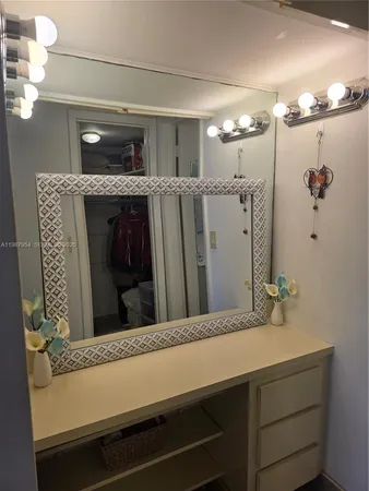 a bathroom with a granite countertop sink a mirror and a shower