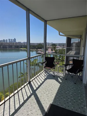 a balcony with wooden floor and outdoor seating