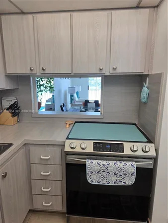 a kitchen with a stove and cabinets