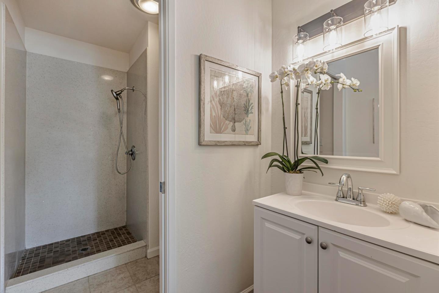 10995 Northseal Square Cupertino, CA 95014 - Photo 16 of 26 a bathroom with a double vanity sink mirror and shower