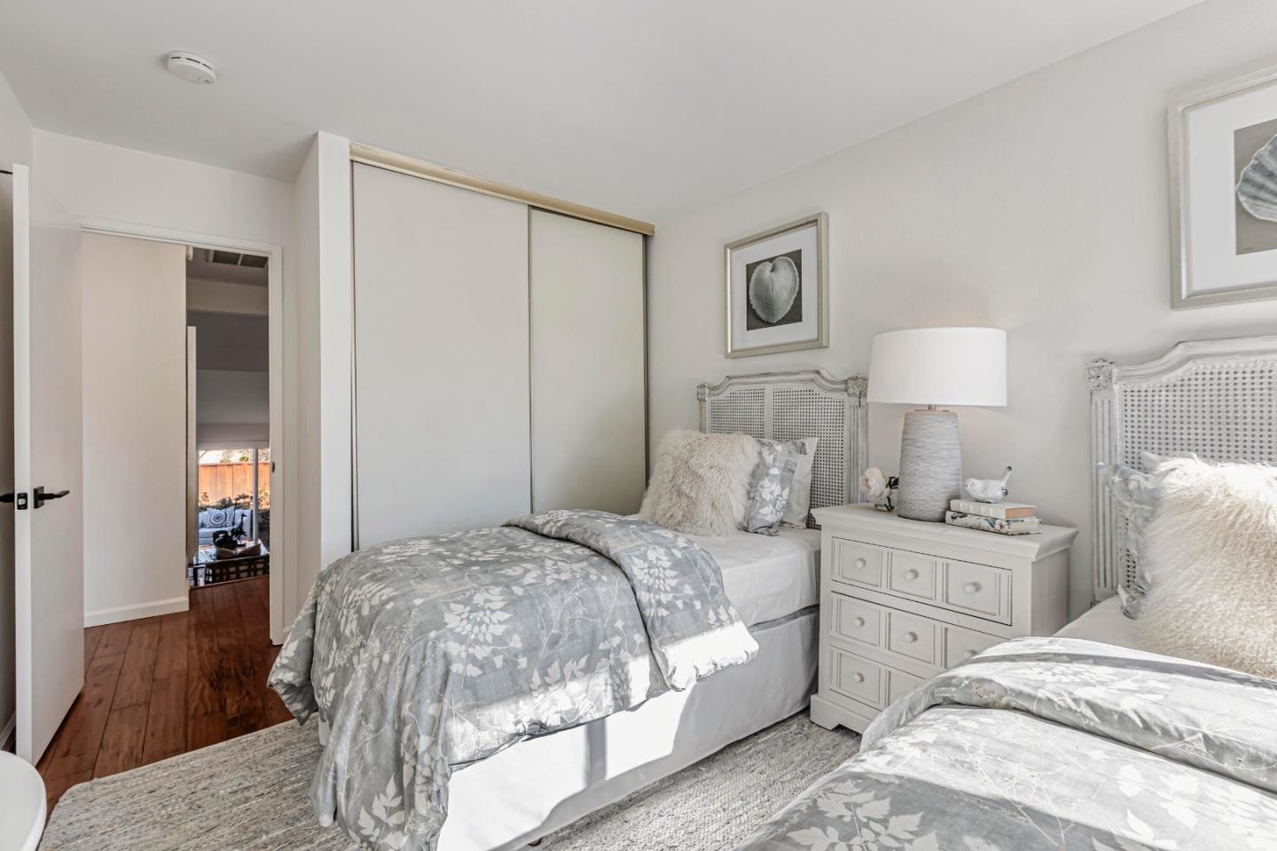 10995 Northseal Square Cupertino, CA 95014 - Photo 17 of 26 a bedroom with a bed and a lamp