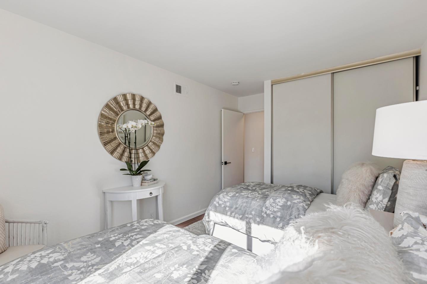 10995 Northseal Square Cupertino, CA 95014 - Photo 18 of 26 a bedroom with a bed and a chandelier