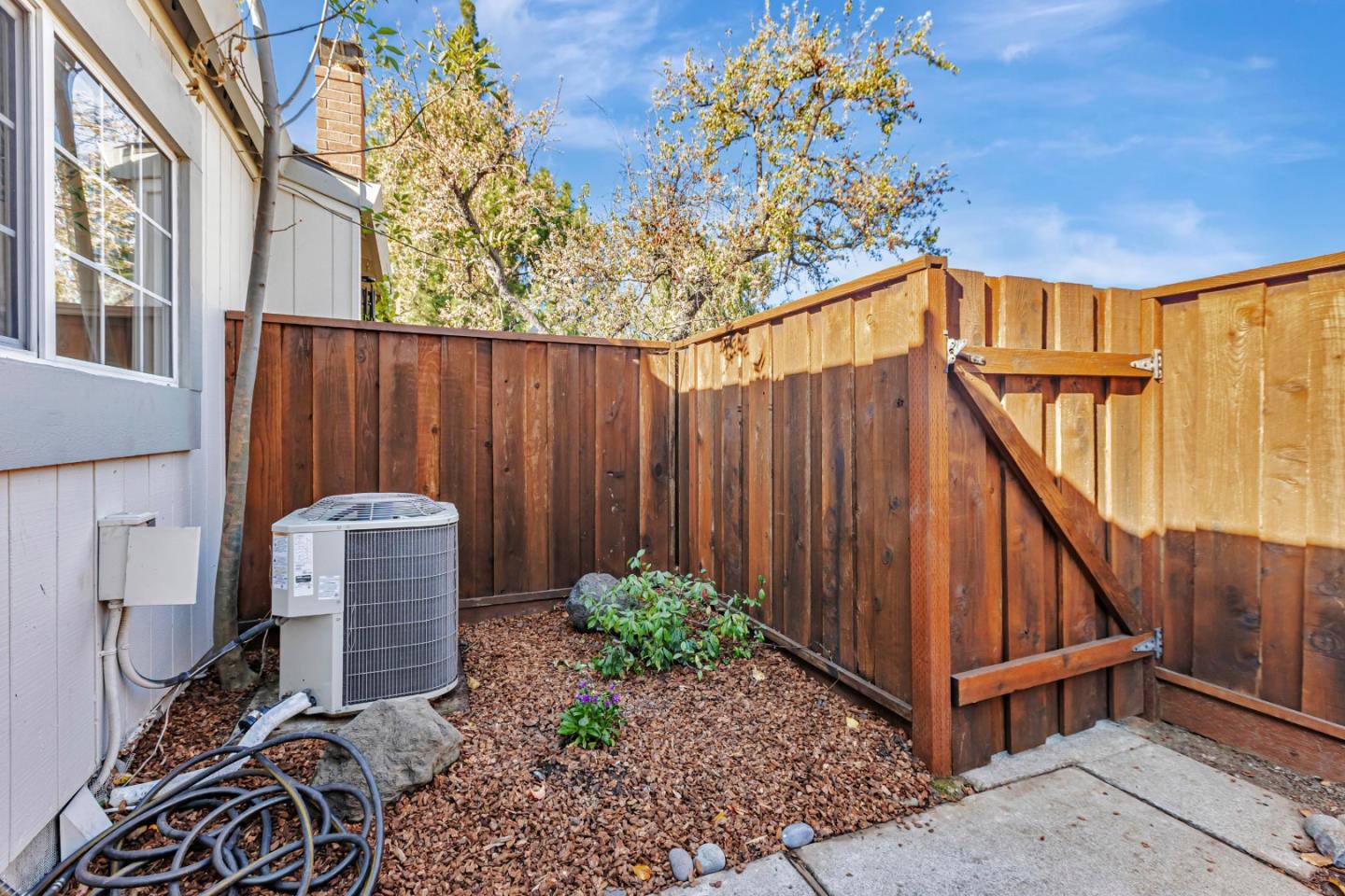 10995 Northseal Square Cupertino, CA 95014 - Photo 24 of 26 a backyard of a house with table and chairs