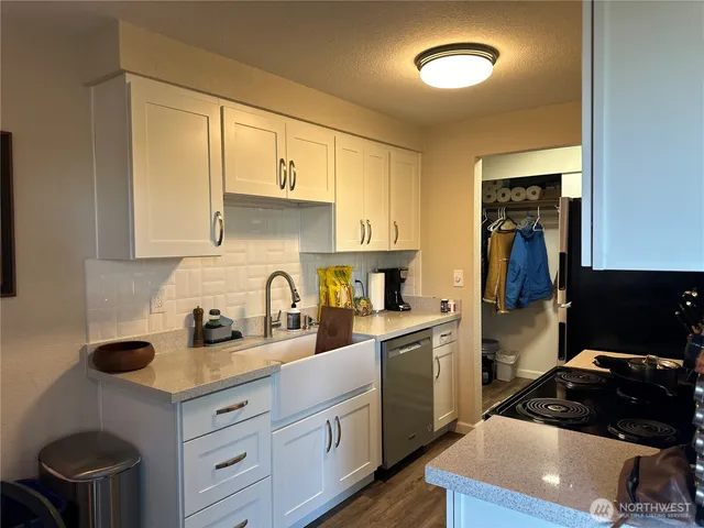 a kitchen with stainless steel appliances granite countertop a refrigerator stove and microwave